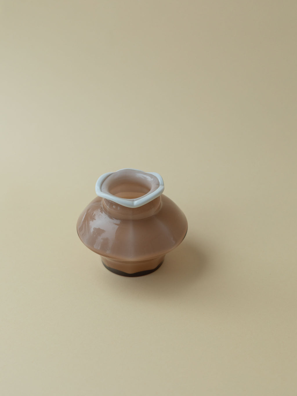 Mouthblown glass vase by Kauklahden Lasi from the 1940s. Brown with white rim. A view from the top angle.