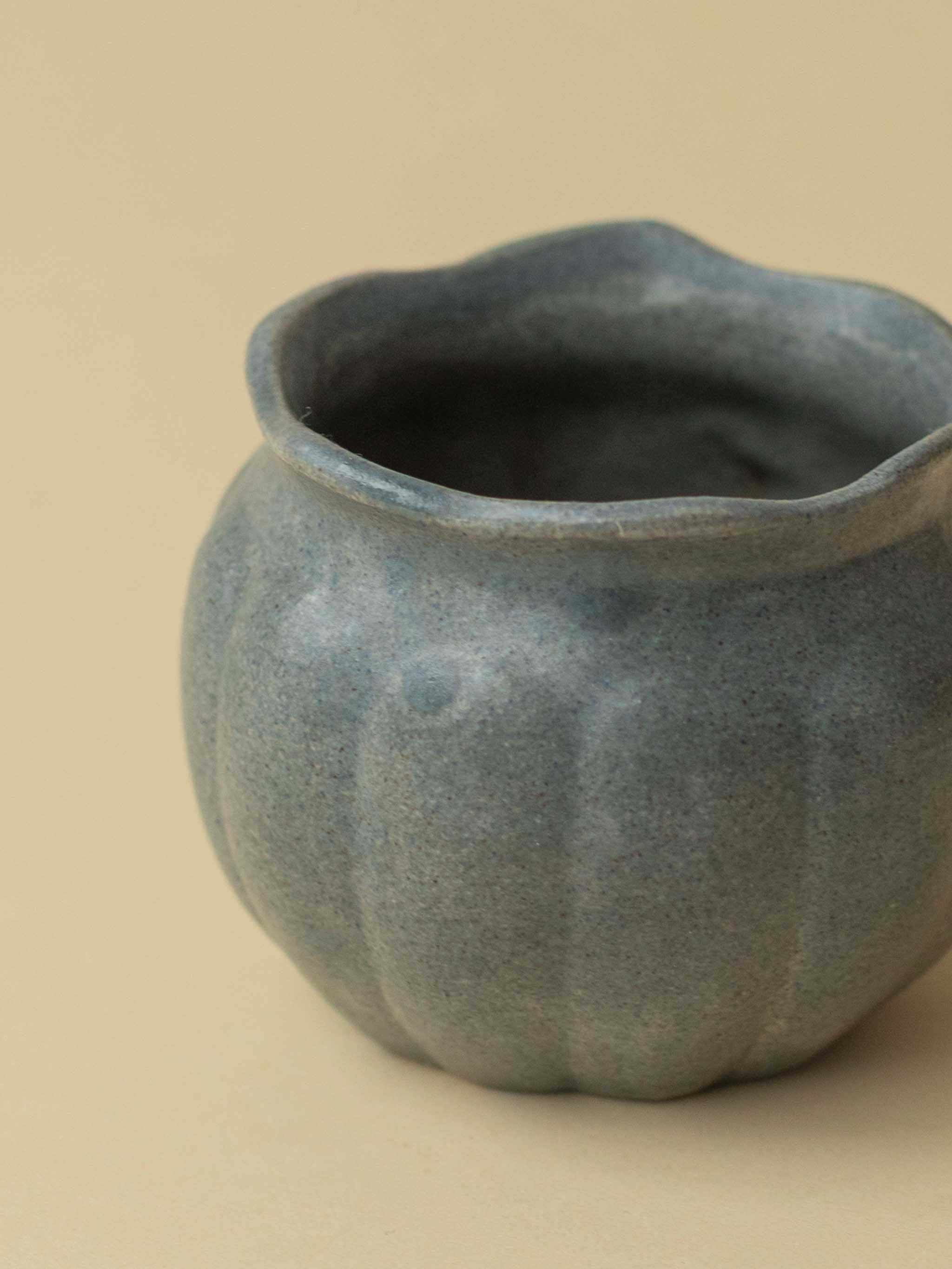 A small grey Kupittaan Savi vintage ceramic vase or pot. A close up view. Scandinavian design from Finland.