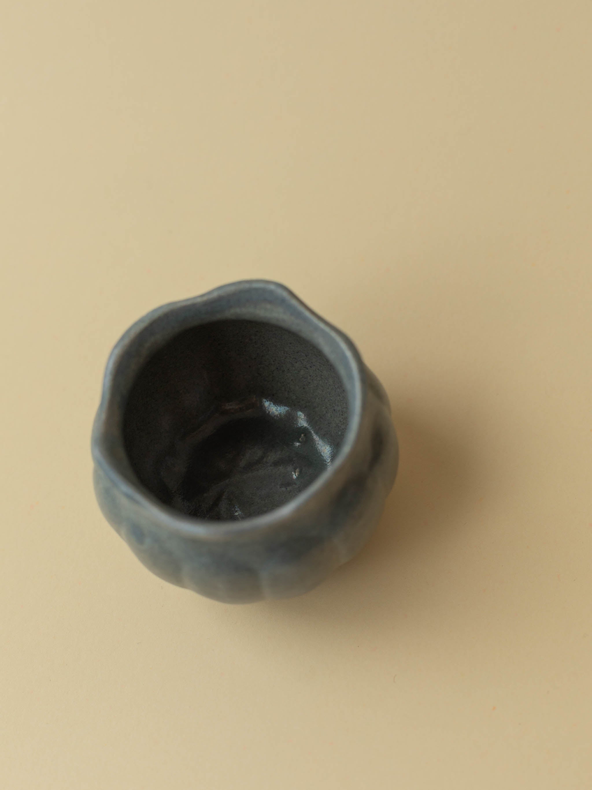 A small grey Kupittaan Savi vintage ceramic vase or pot. A view from the top showing the inside of the vase. Scandinavian design from Finland.