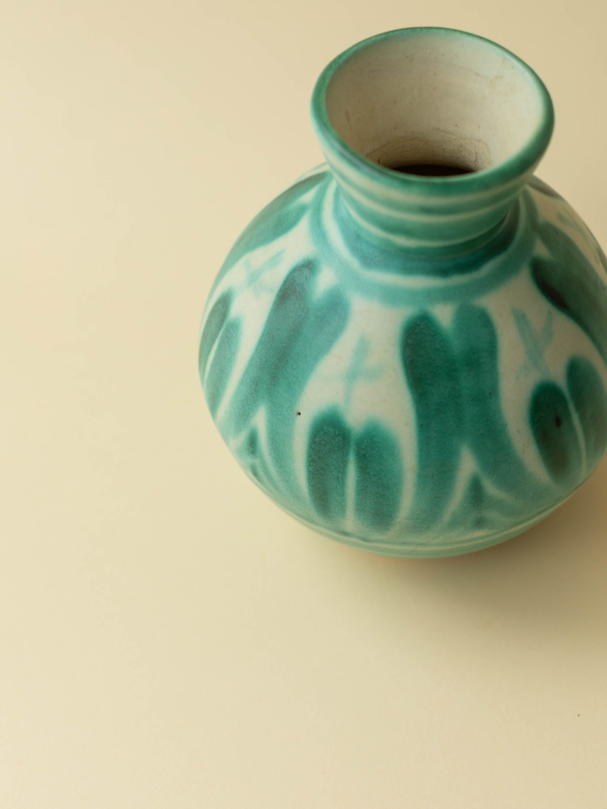 A green hand painted ceramic vintage vase by Kupittaan Savi. Scandinavian vintage vase from Finland. A close up from above.