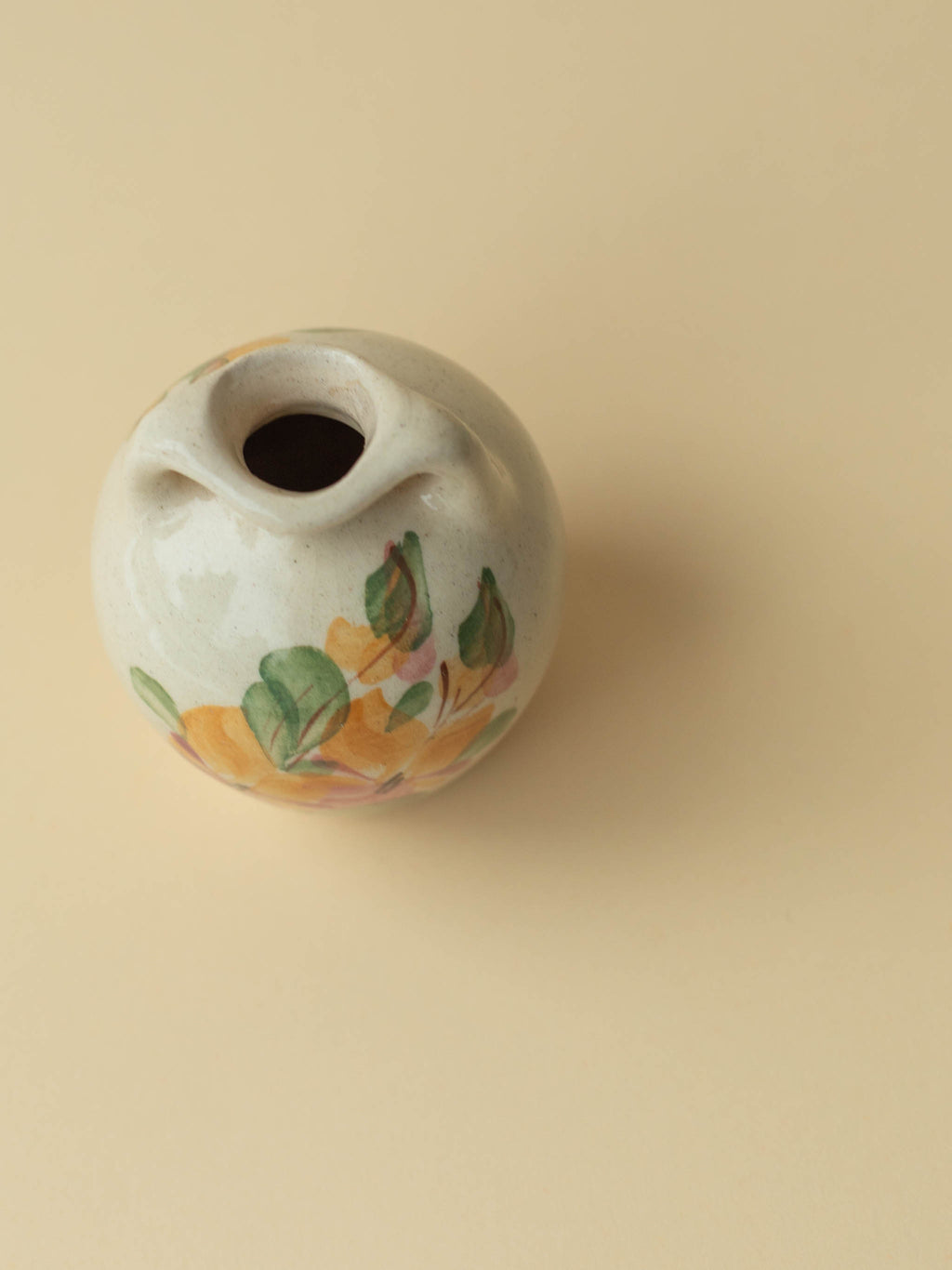 A miniature Kupittaan Savi vintage ceramic vase in amphora form.  Hand painted floral motif. A view from the top. Scandinavian design from Finland.