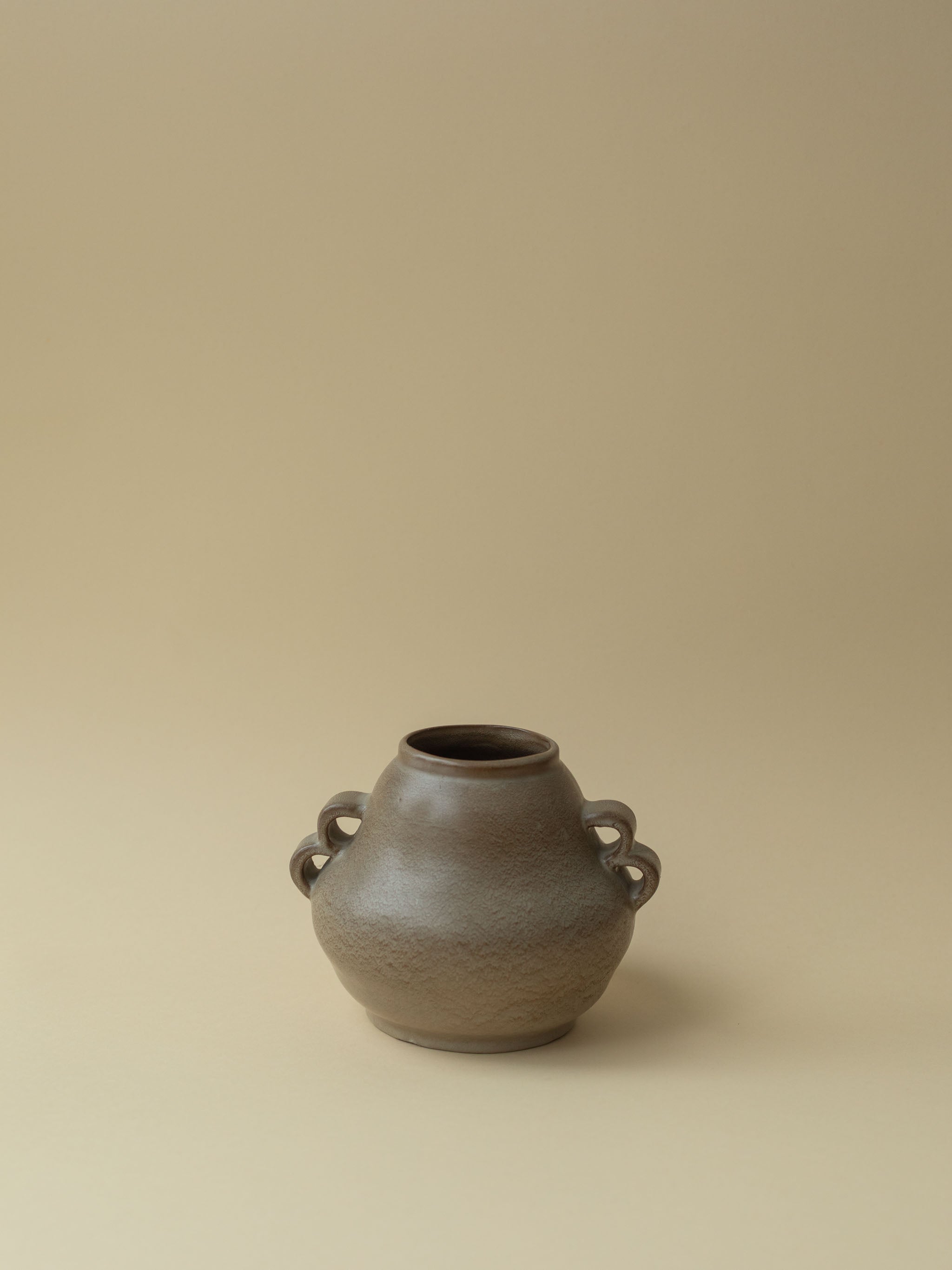 A brown vintage ceramic vase by Kupittaan Savi. Scandinavian design from Finland.