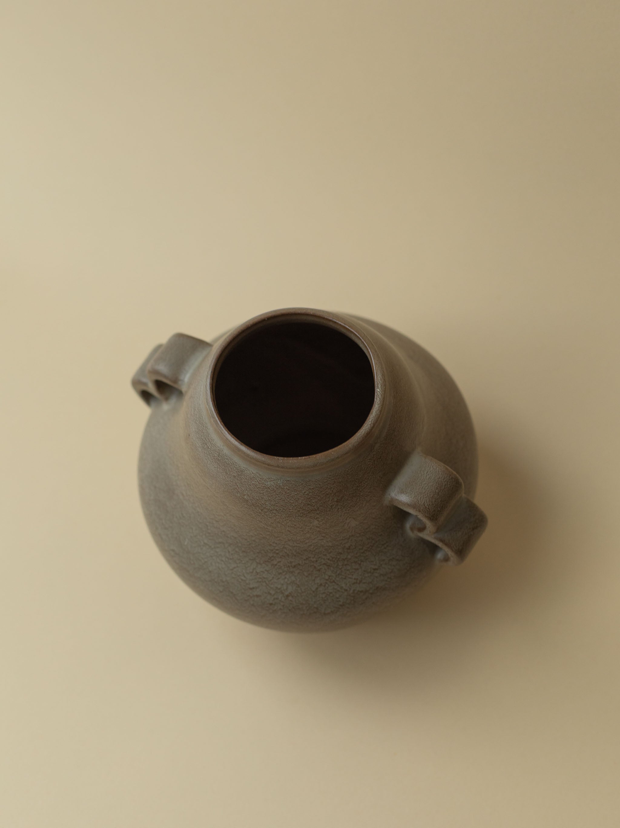 A brown vintage ceramic vase by Kupittaan Savi. Scandinavian design from Finland. Top view.