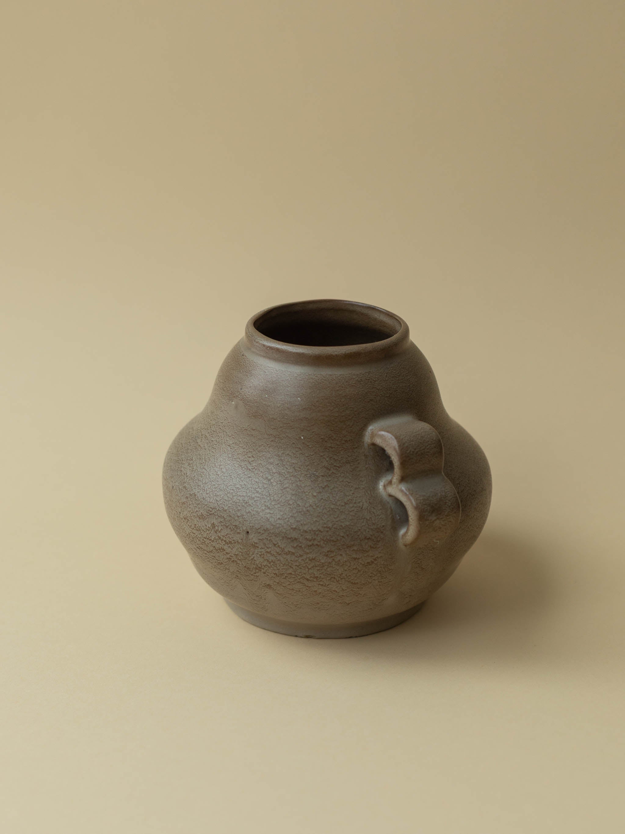 A brown vintage ceramic vase by Kupittaan Savi. Scandinavian design from Finland. A view from the side. 