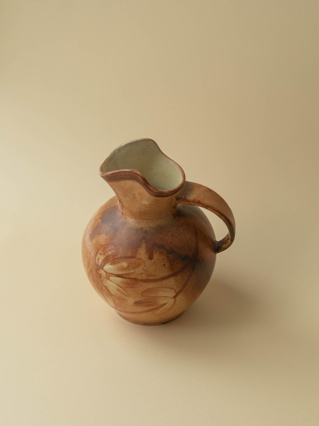 A brown toned vintage ceramic vase by Kupittaan Savi in jug or pitcher form.  Scandinavian design from Finland. 