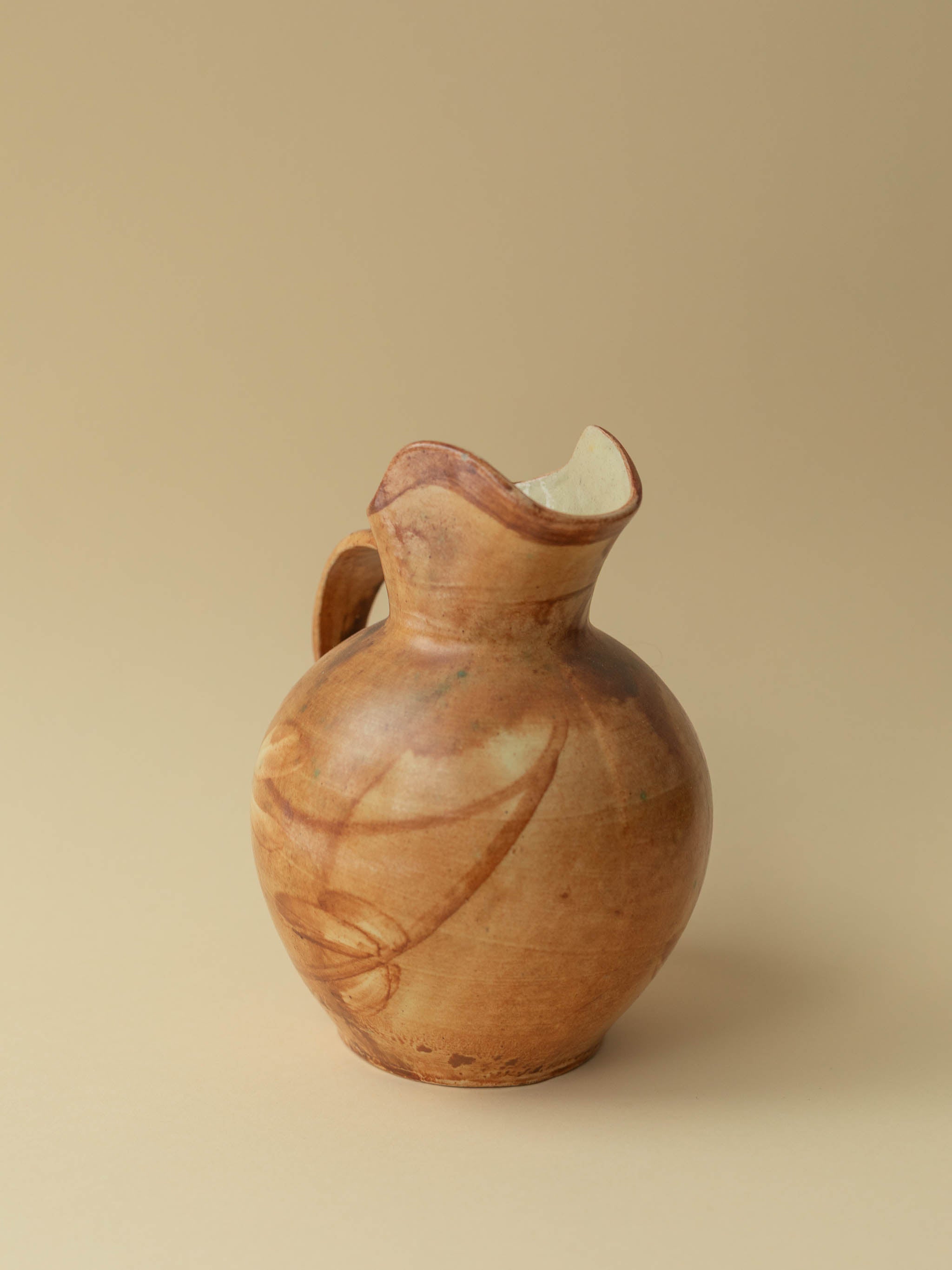 A brown toned vintage ceramic vase by Kupittaan Savi in jug or pitcher form. Signed at the bottom. Scandinavian design from Finland. 