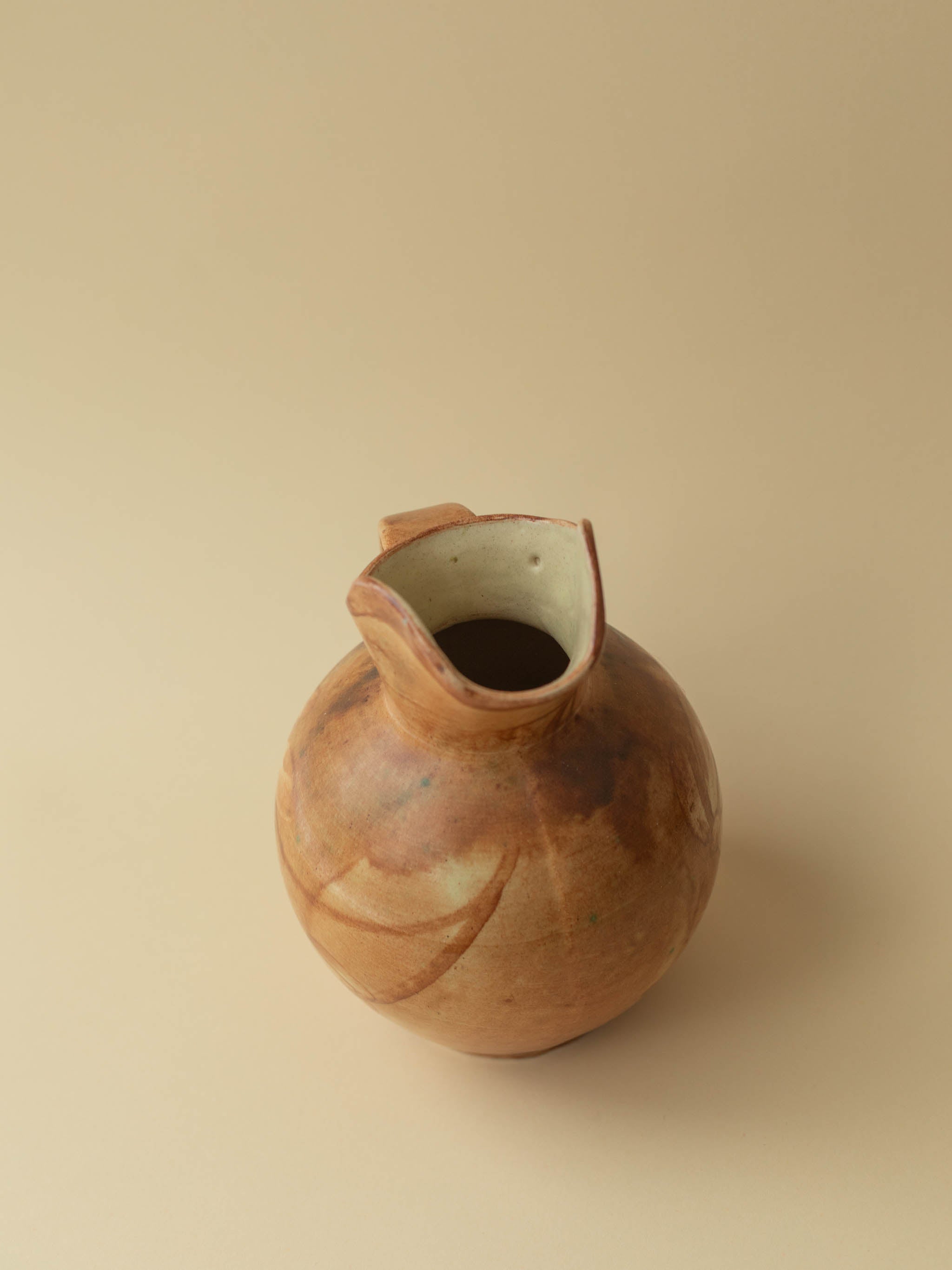 A brown toned vintage ceramic vase by Kupittaan Savi in jug or pitcher form. Scandinavian design from Finland. A view from above.