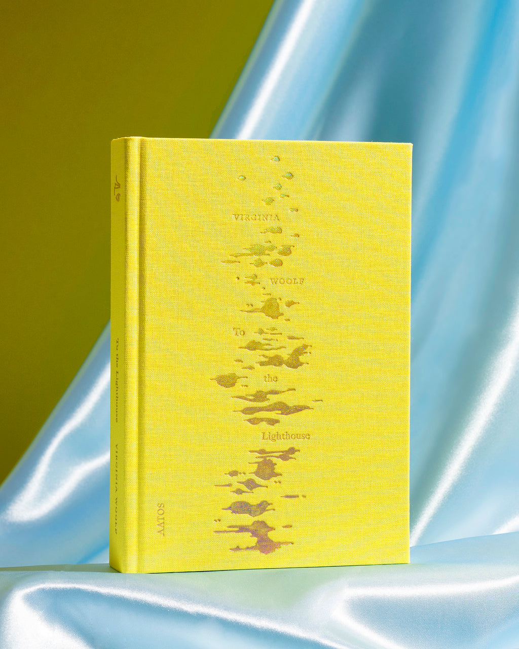 Virginia Woolf's To the Lighthouse book by published by Aatos Editions. The book is on a light blue background with shadows.
